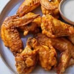 Pinterest graphic of a plate of air fryer chicken wings.