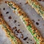 Pinterest graphic of a close up of asparagus fries on a sheet pan.