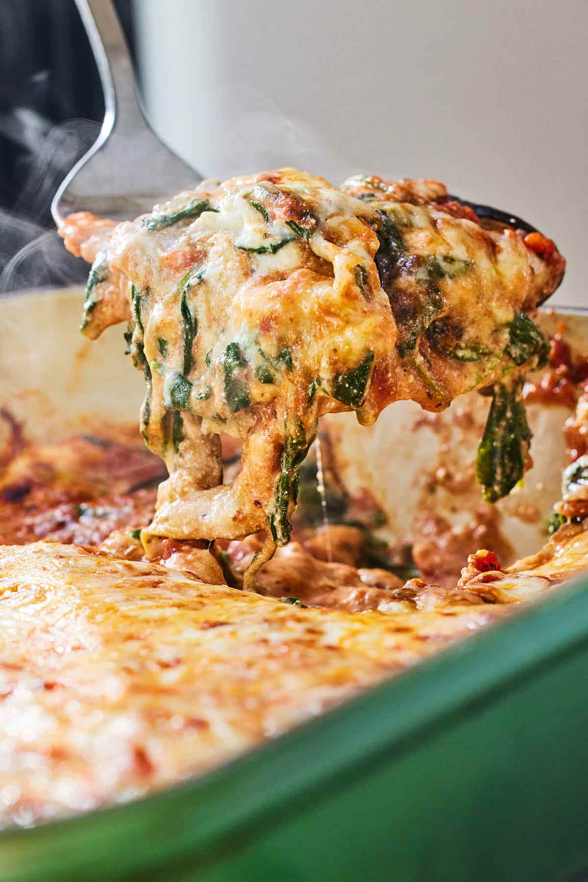 A serving of eggplant lasagna lifted from the casserole dish.