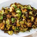 A white platter with air fryer Brussels sprouts.