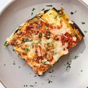 A square piece of eggplant lasagna on a plate.