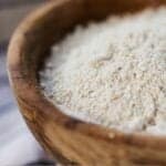 Pinterest graphic of a close up view of oat flour in a bowl.