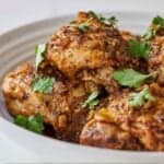 Pinterest graphic of the side view of a bowl of Instant Pot lemon garlic chicken thighs.