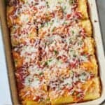 Pinterest graphic of an overhead view of a casserole dish of lasagna roll ups.