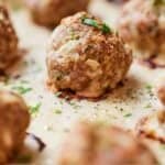 Pinterest graphic of a turkey meatball in focus with the rest around it blurry.