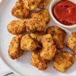 Pinterest graphic of a plate of air fryer chicken nuggets by a small bowl of ketchup.