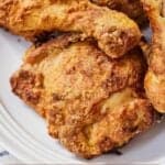 Pinterest graphic of a close view of air fryer fried chicken on a plate.