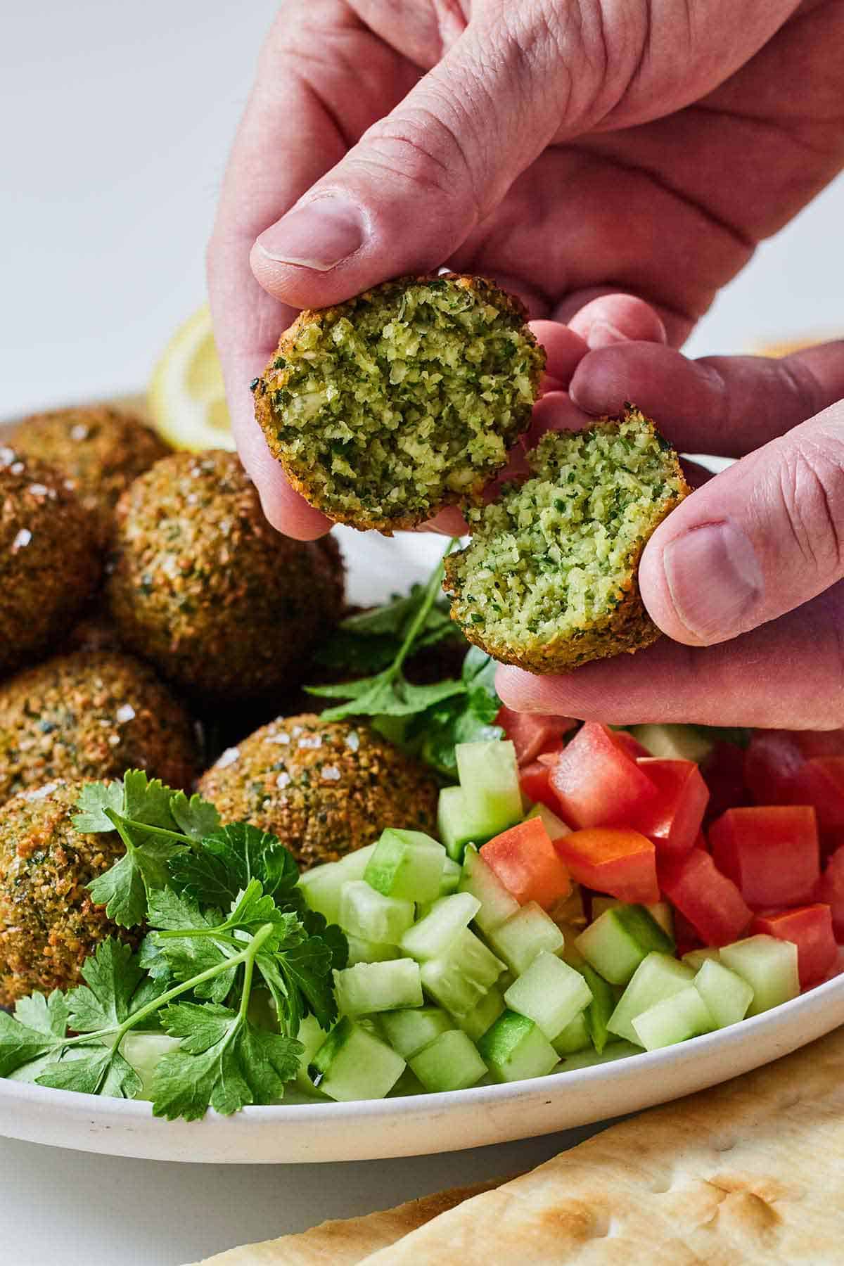 A falafel torn in half by hand.
