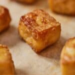 Pinterest graphic of a close view of a baked tofu on a sheet pan.