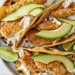 Pinterest graphic of an overhead view of three air fryer fish tacos on a plate.