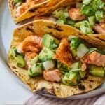 Pinterest graphic of three salmon tacos on a plate.
