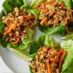 Pinterest graphic of an overhead view of three Thai chicken lettuce wraps.