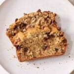 Overhead view of two slices of gluten free chocolate chip banana bread on a plate.