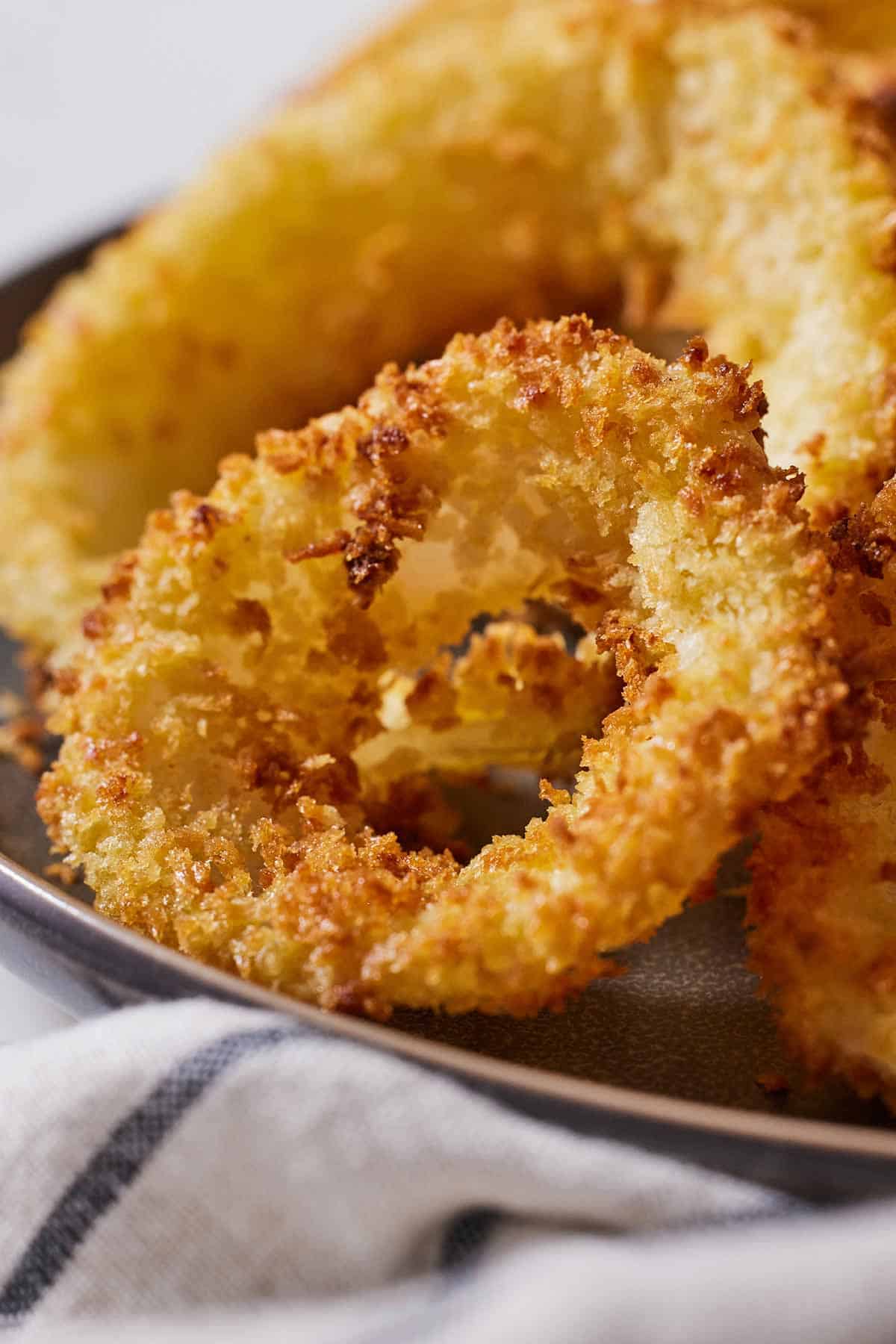 Close up view of a crispy, golden air fryer onion ring.