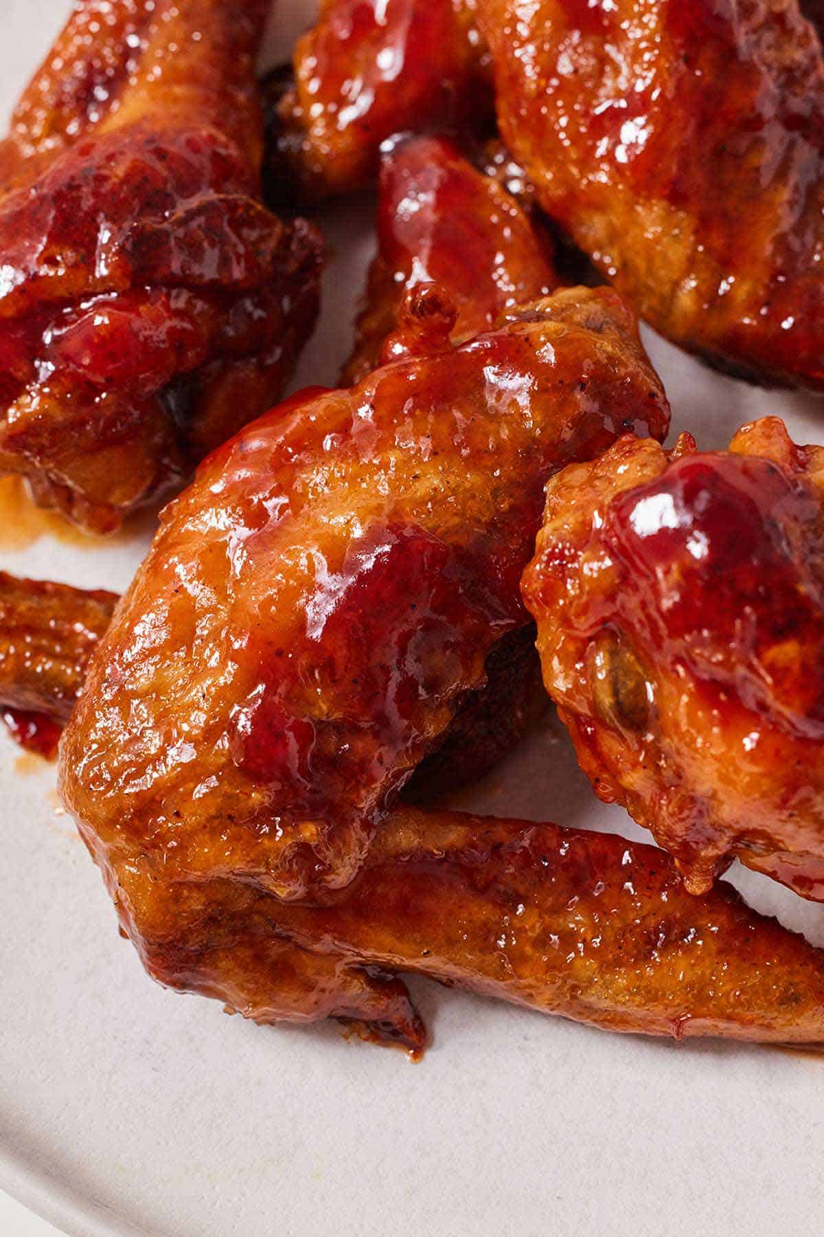 Close up of honey BBQ chicken wings on a plate.