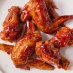 Pinterest graphic of a plate of honey BBQ wings.