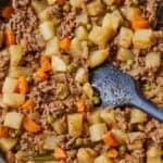 Pinterest graphic of a skillet of Mexican picadillo with a spatula stirring it.