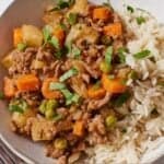 Pinterest graphic of Mexican picadillo with rice in a bowl garnished with chopped cilantro.