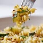 Pinterest graphic of a fork with summer squash pasta lifted from a bowl of pasta.
