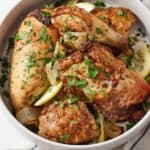 Pinterest graphic of an overhead view of a bowl of air fryer Lebanese chicken with fresh parsley on top.
