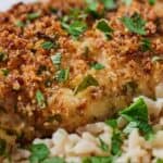 Pinterest graphic of a close up view of a serving of air fryer parmesan crusted chicken with chopped parsley on top.