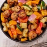 Pinterest graphic of an overhead view of a bowl of air fryer sausage and vegetables.