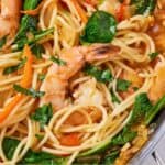 Pinterest graphic of a close up view of red curry pasta with shrimp with parsley on top.