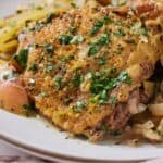 Pinterest graphic of a close view of apple cider chicken with chopped parsley on top.