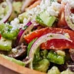 Pinterest graphic of a close up view of the vegetables inside of the avocado Greek salad.