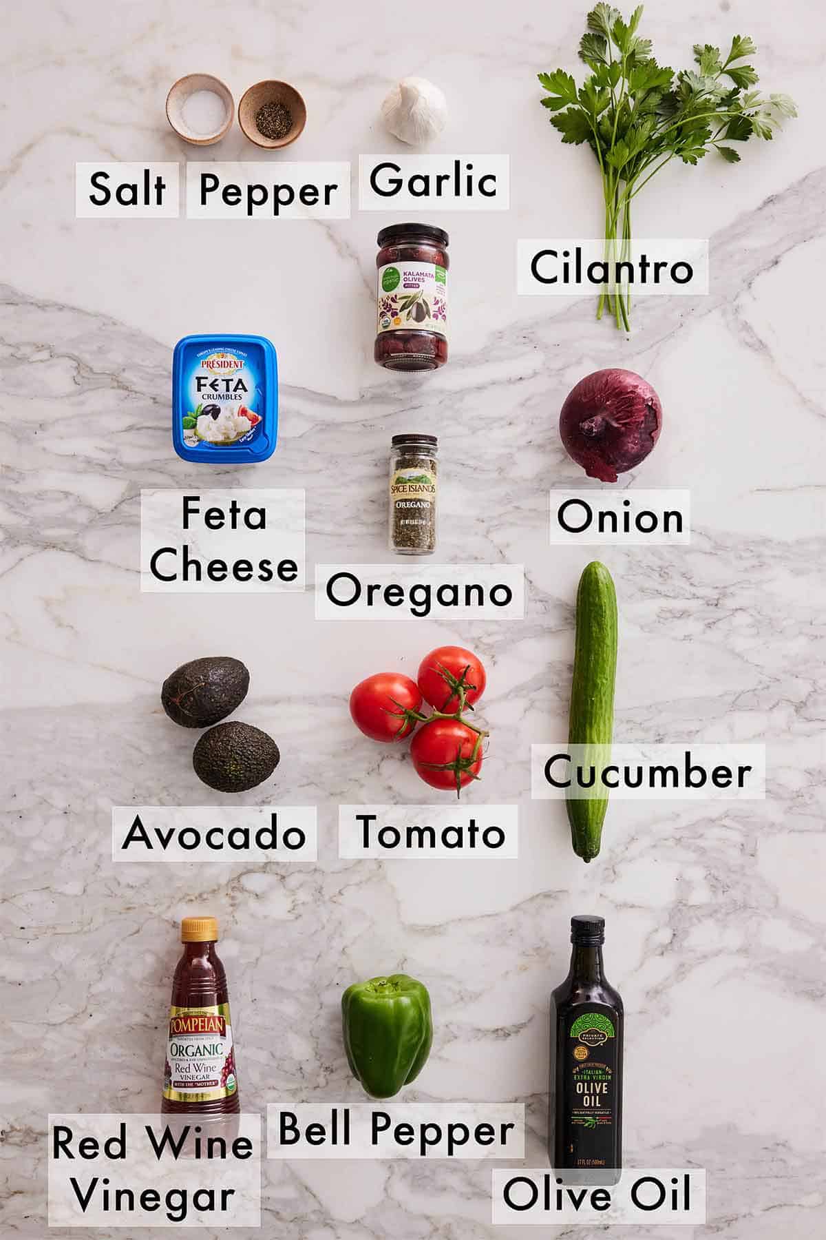 Ingredients needed to make avocado Greek salad.